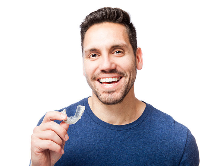happy man holding Invisalign