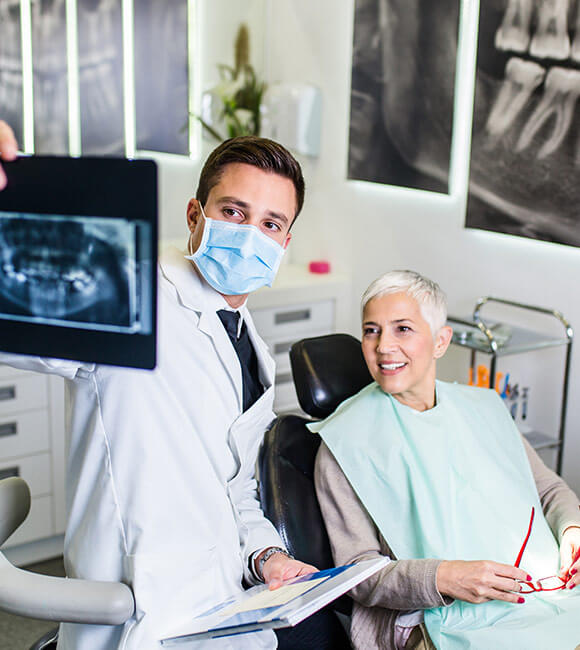 dentist showing patient x-rays