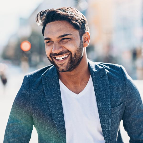 man smiling with blue blazer