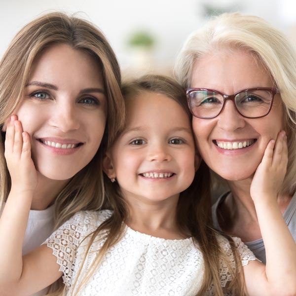 girl besides two women smiling